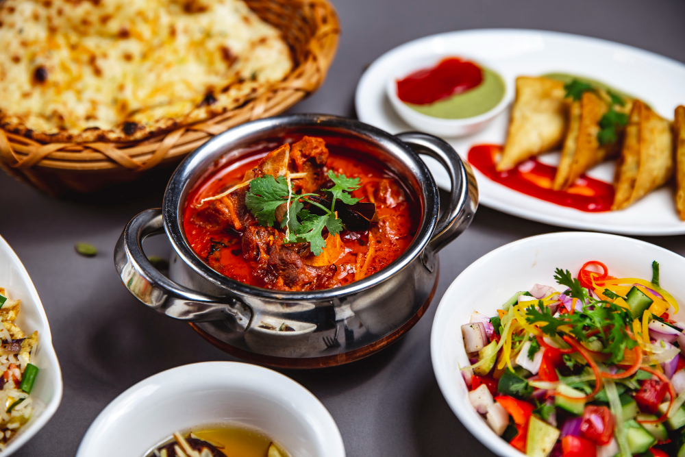 A shared table of curries, and naan at Karma Indian Bistro in Kitsilano